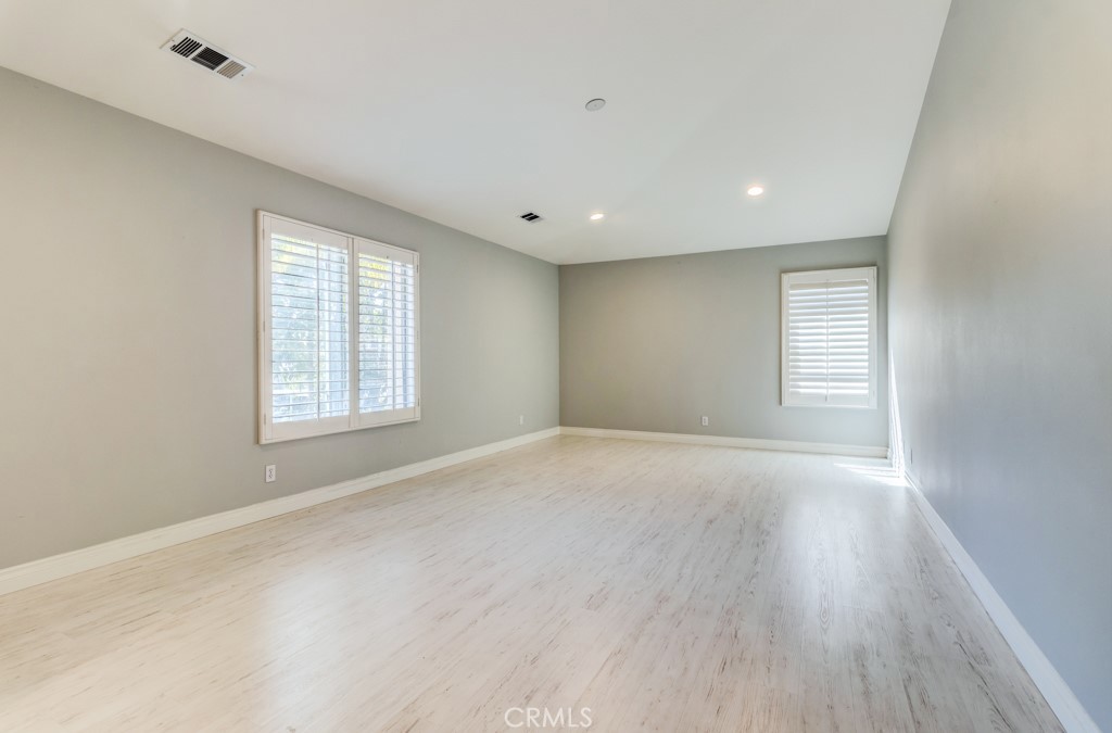 8 Zinnia Irvine, CA 92618 - Photo 33 of 39 an empty room with wooden floor and windows