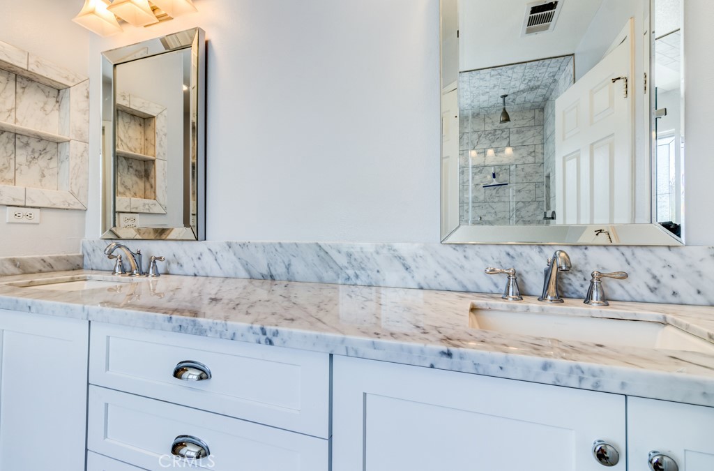 8 Zinnia Irvine, CA 92618 - Photo 35 of 39 a bathroom with a granite countertop sink and a mirror