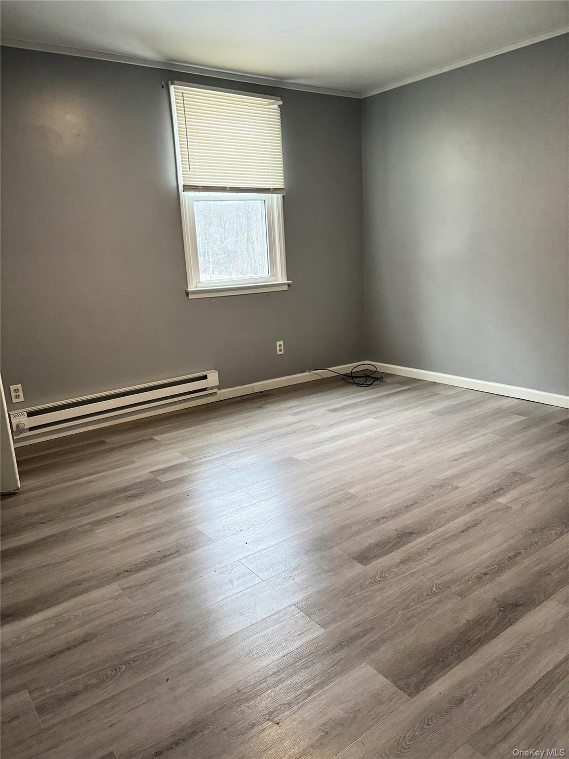 210 Mt Prosper Road Wurtsboro, NY 12790 - Photo 12 of 14 an empty room with wooden floor and windows