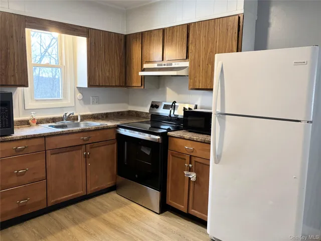 a kitchen with a refrigerator and a sink