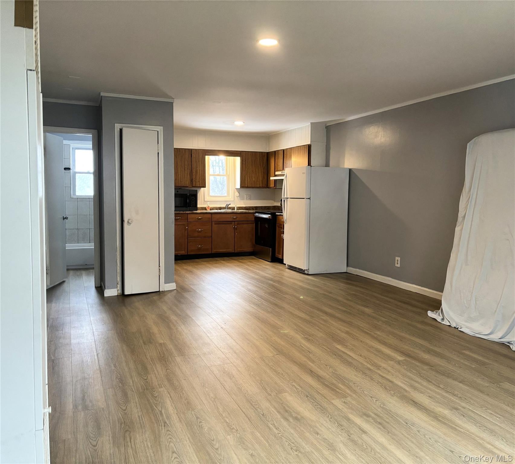 210 Mt Prosper Road Wurtsboro, NY 12790 - Photo 6 of 14 a view of a kitchen with a sink and a refrigerator