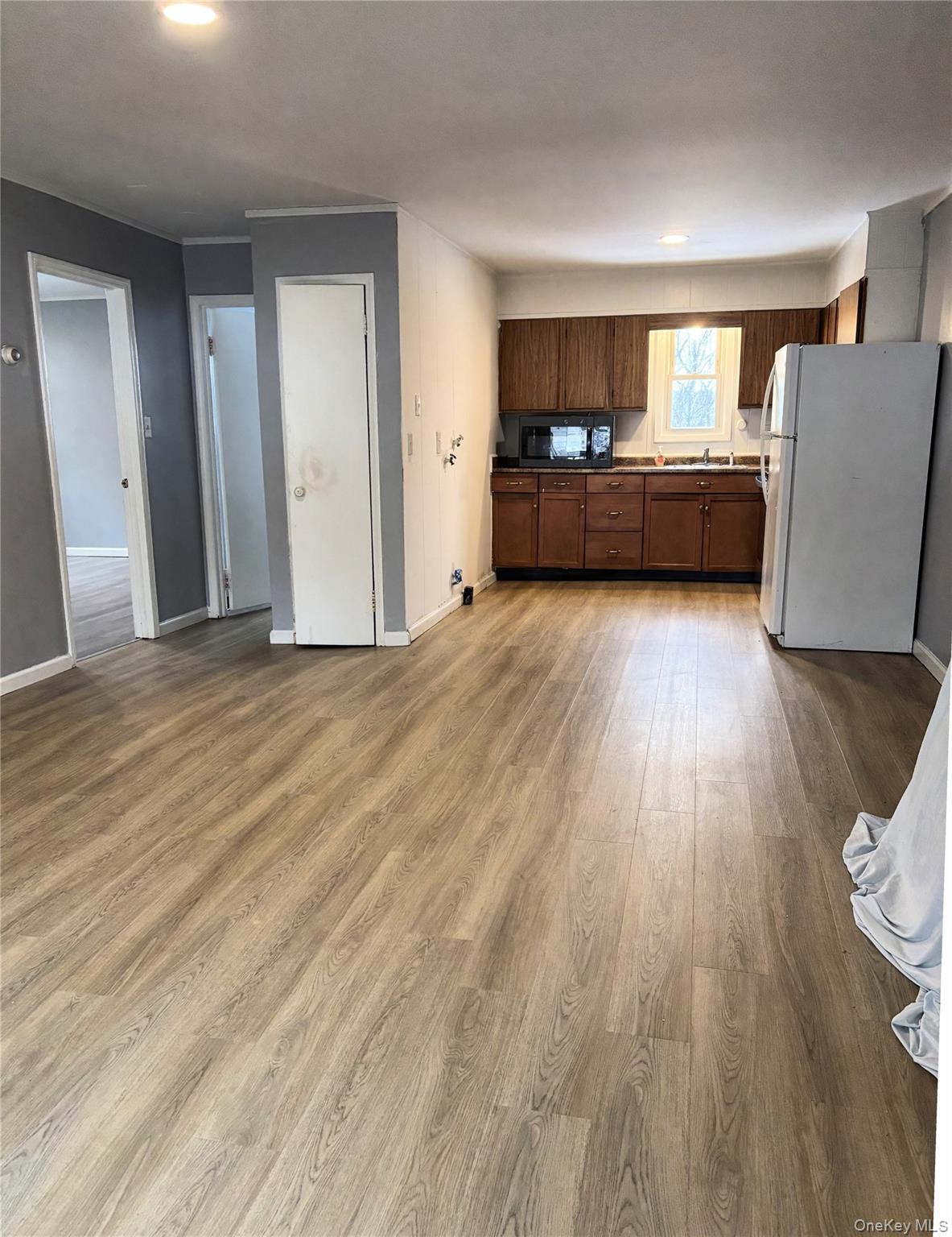 210 Mt Prosper Road Wurtsboro, NY 12790 - Photo 8 of 15 wooden floor in an empty room with a window