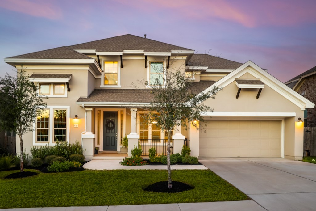 a front view of a house with a yard and garage