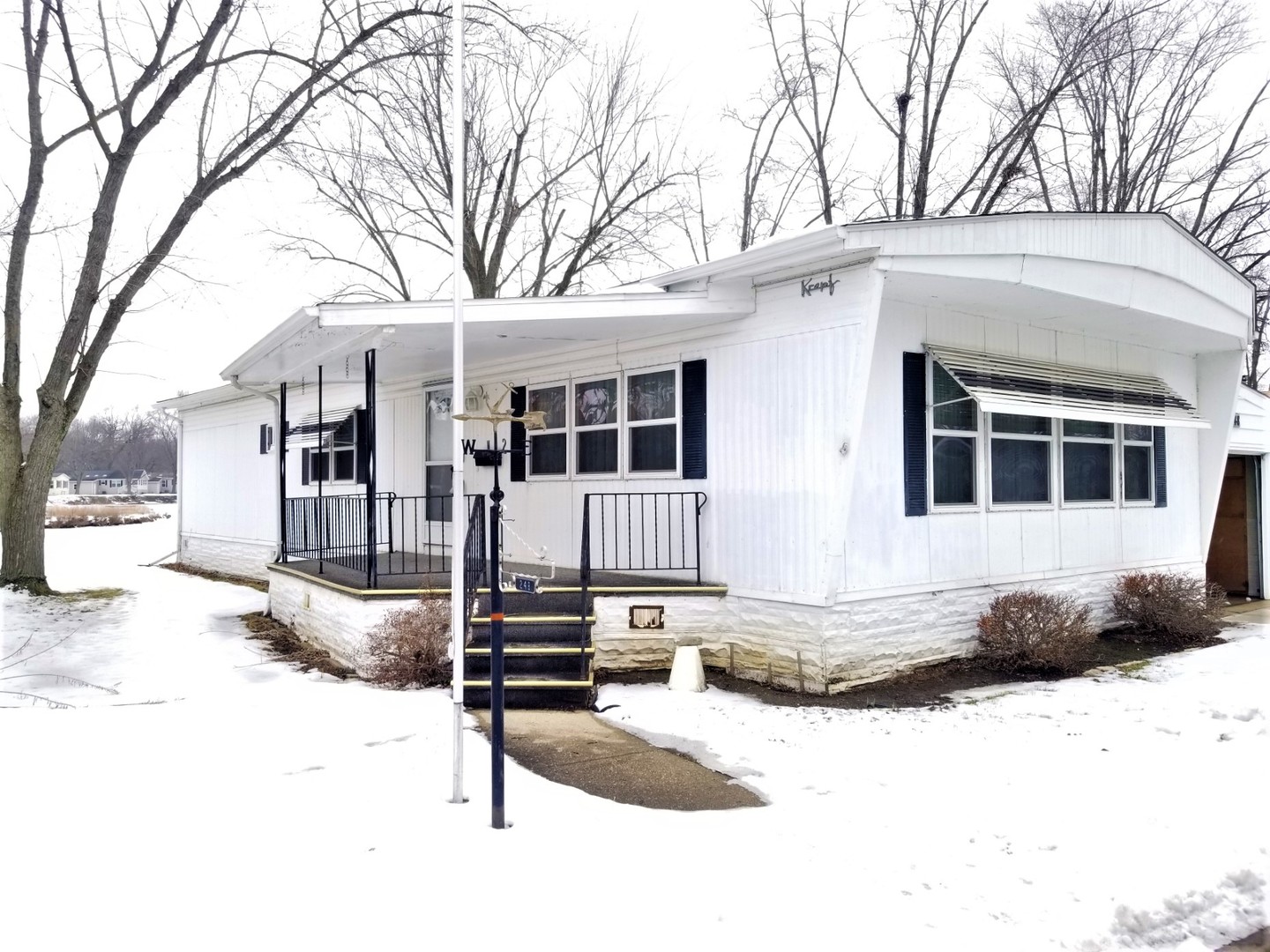 248 Bayview Road Elgin, IL 60123 - Photo 1 of 13 a front view of a house with a yard covered in snow