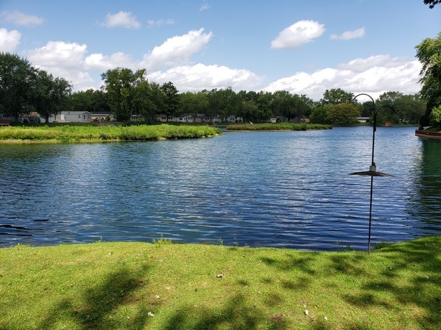 248 Bayview Road Elgin, IL 60123 - Photo 2 of 13 a view of a lake with a big yard