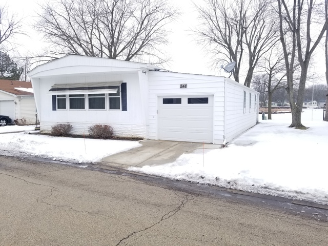 248 Bayview Road Elgin, IL 60123 - Photo 3 of 13 a front view of a house with a yard covered in snow