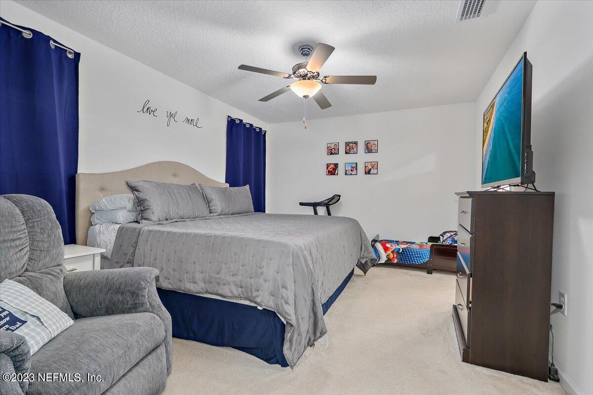 8300 Guild Way Jacksonville, FL 32222 - Photo 12 of 18 a bedroom with a bed couch and a window