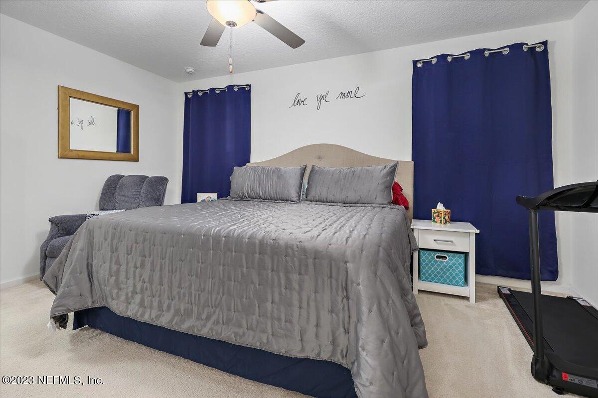 8300 Guild Way Jacksonville, FL 32222 - Photo 13 of 18 a bedroom with a bed and a painting on the wall