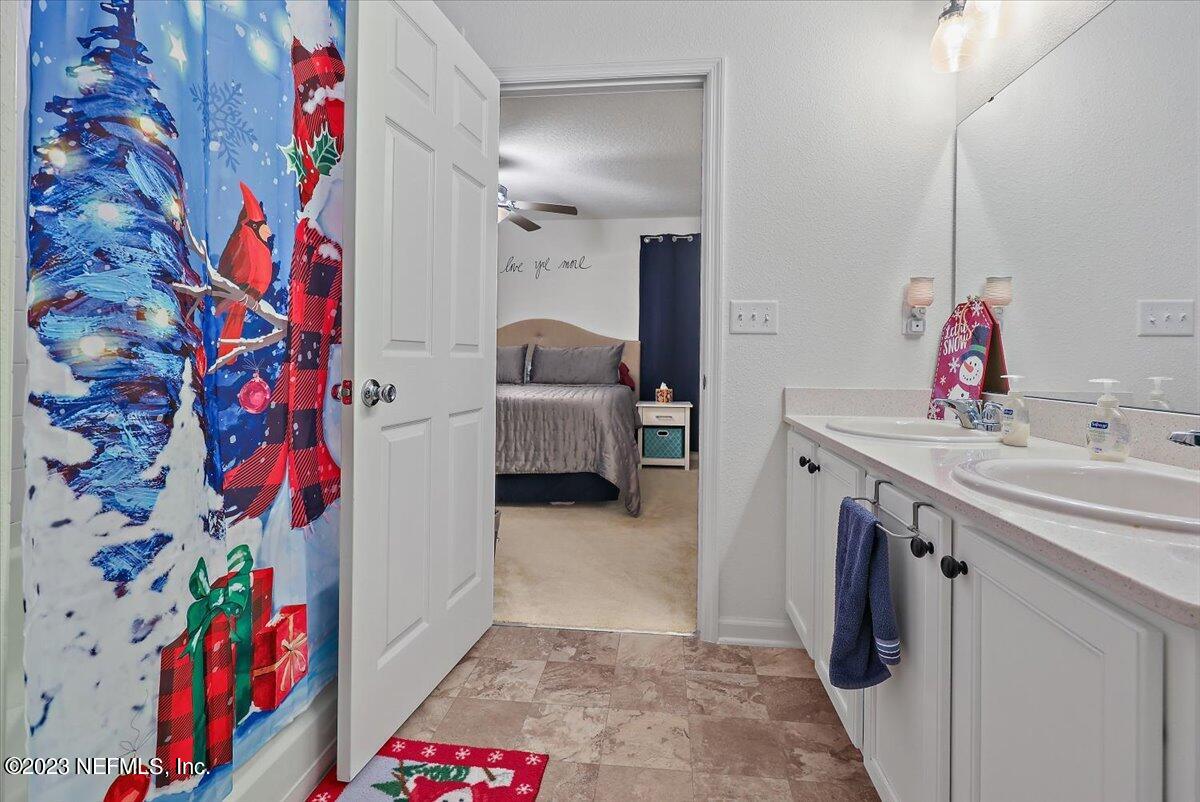8300 Guild Way Jacksonville, FL 32222 - Photo 14 of 18 a bathroom with a sink mirror and vanity