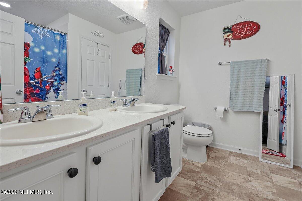 8300 Guild Way Jacksonville, FL 32222 - Photo 15 of 18 a bathroom with a sink a vanity and a mirror