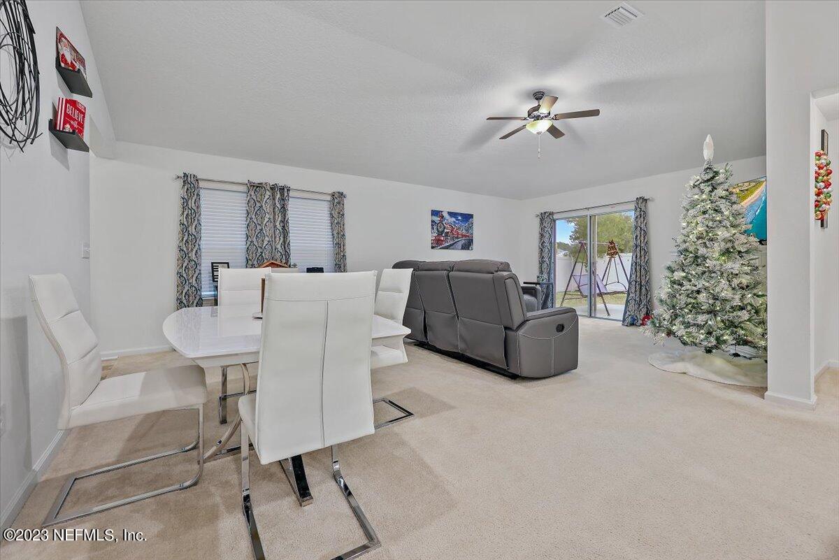 8300 Guild Way Jacksonville, FL 32222 - Photo 5 of 18 a living room with furniture and a chandelier