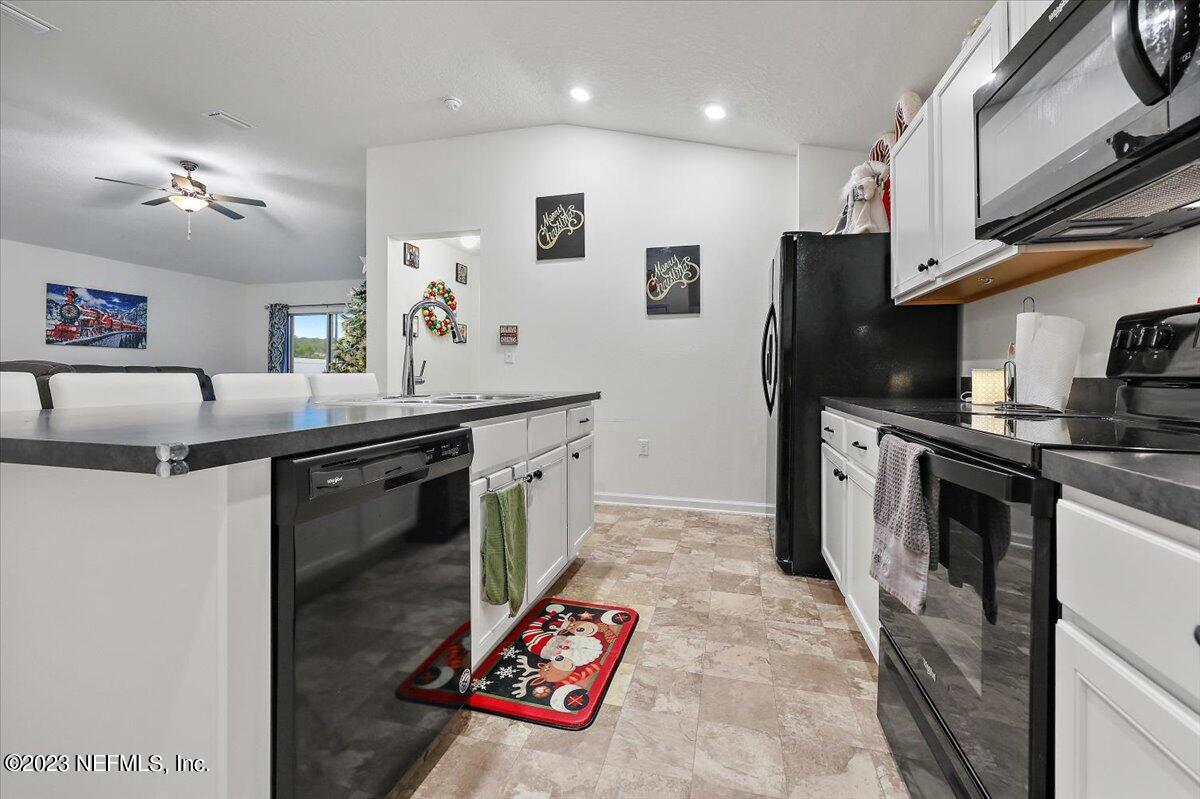 8300 Guild Way Jacksonville, FL 32222 - Photo 8 of 18 a kitchen with stainless steel appliances granite countertop a sink refrigerator and microwave