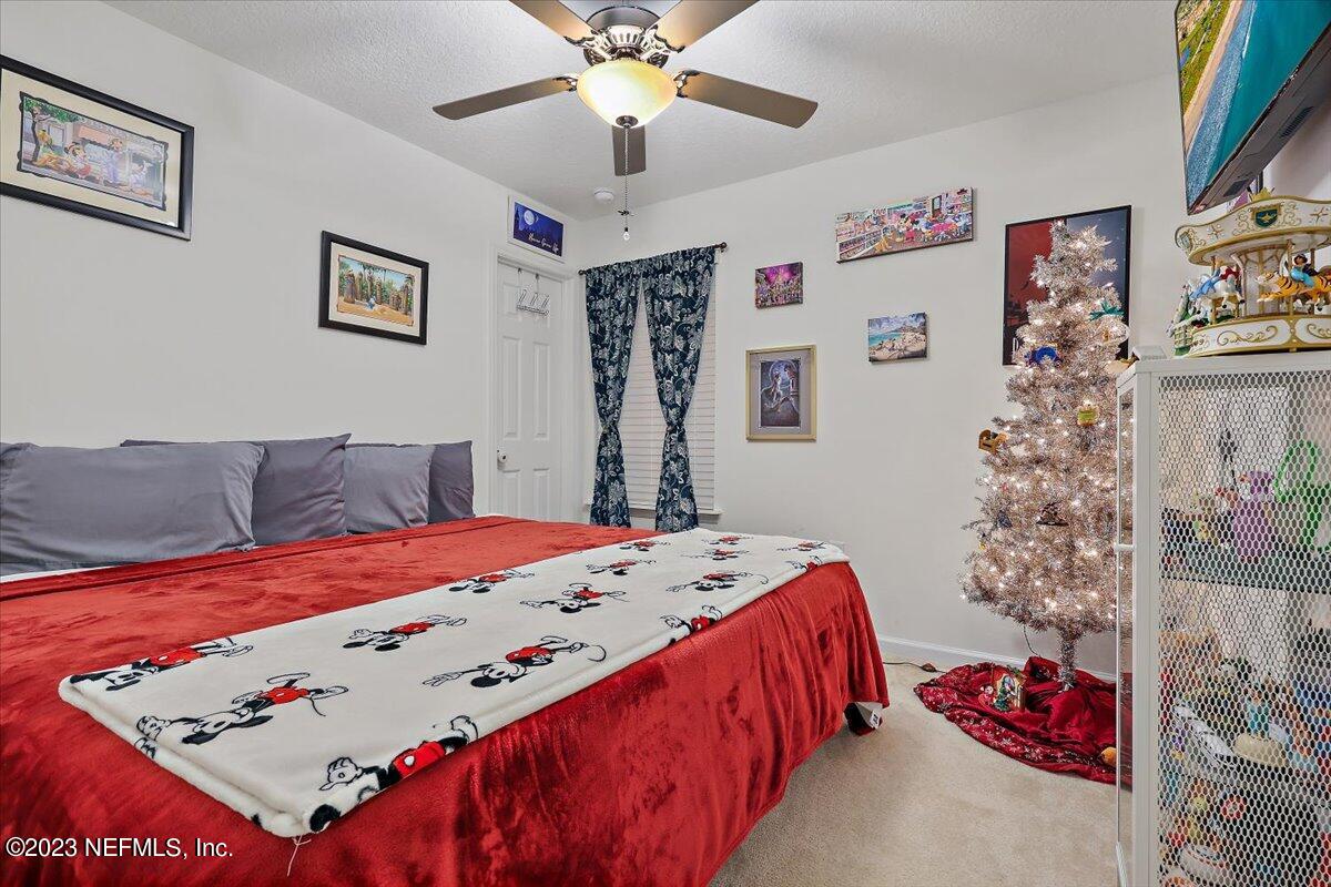 8300 Guild Way Jacksonville, FL 32222 - Photo 10 of 18 a bedroom with a bed and a dresser in it