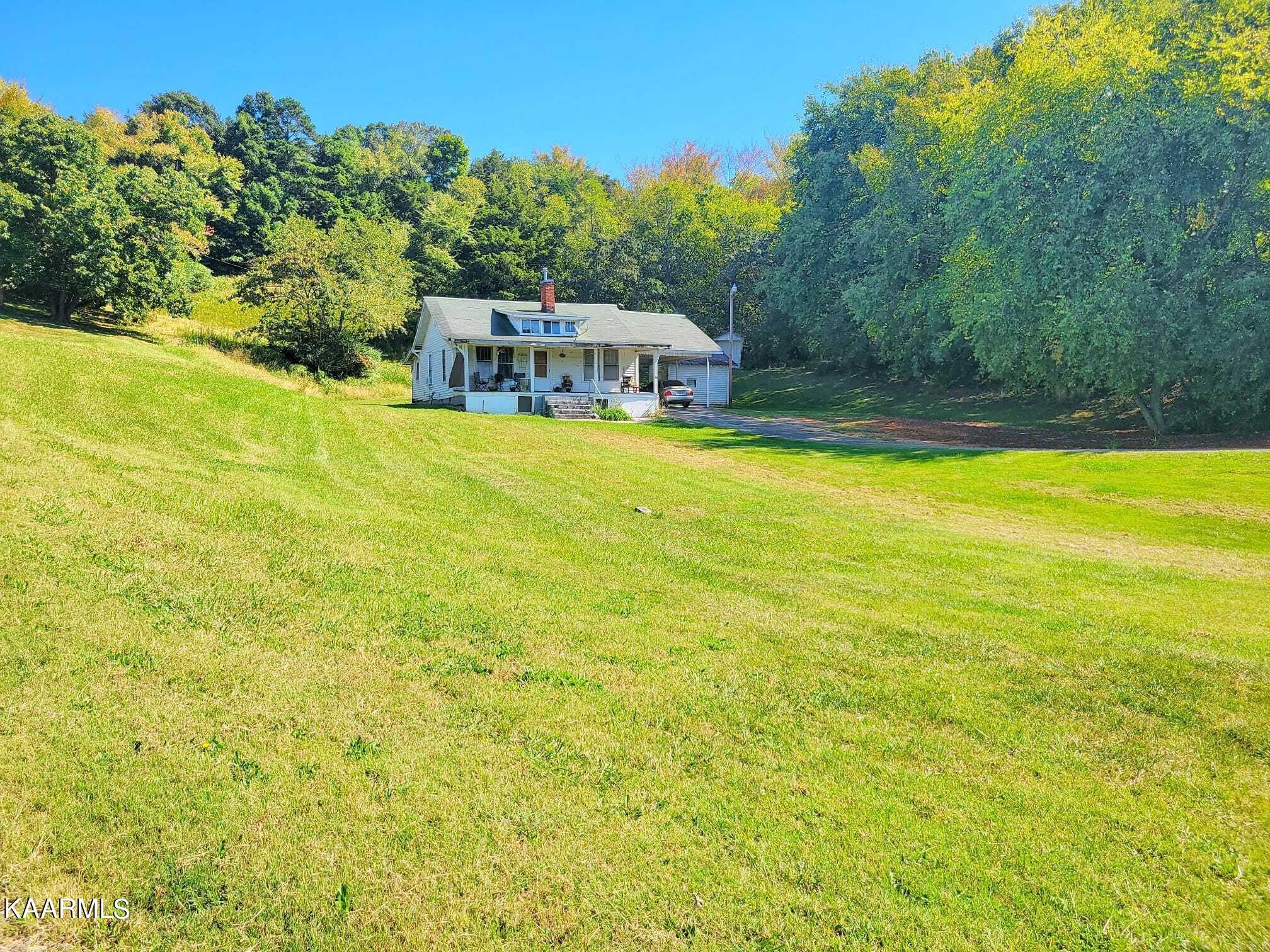 104 Highway 160 Newport, TN 37821 - Photo 2 of 24 a view of a swimming pool with an outdoor seating and a yard