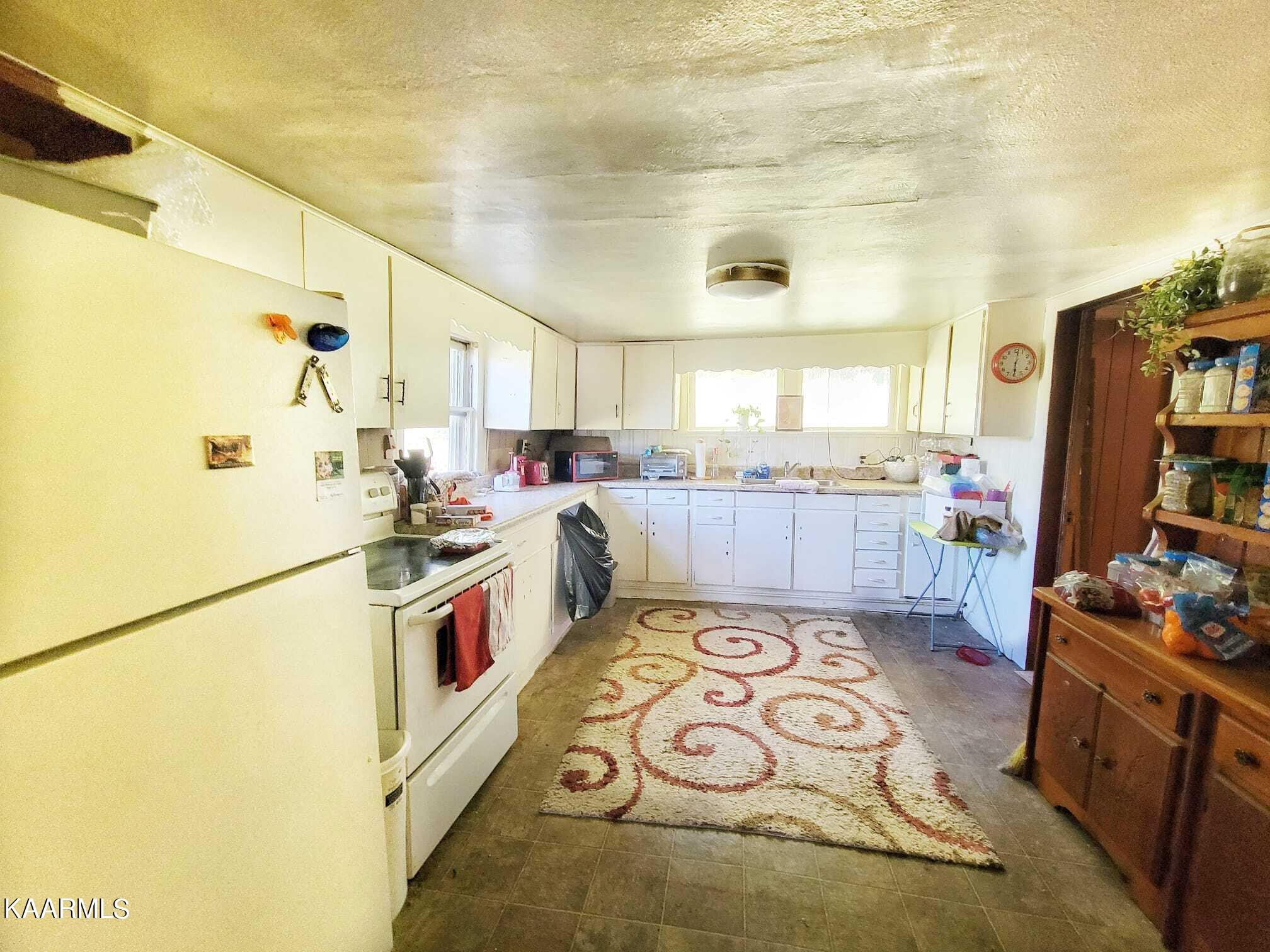 104 Highway 160 Newport, TN 37821 - Photo 22 of 24 a kitchen with stainless steel appliances granite countertop a stove a sink and a refrigerator