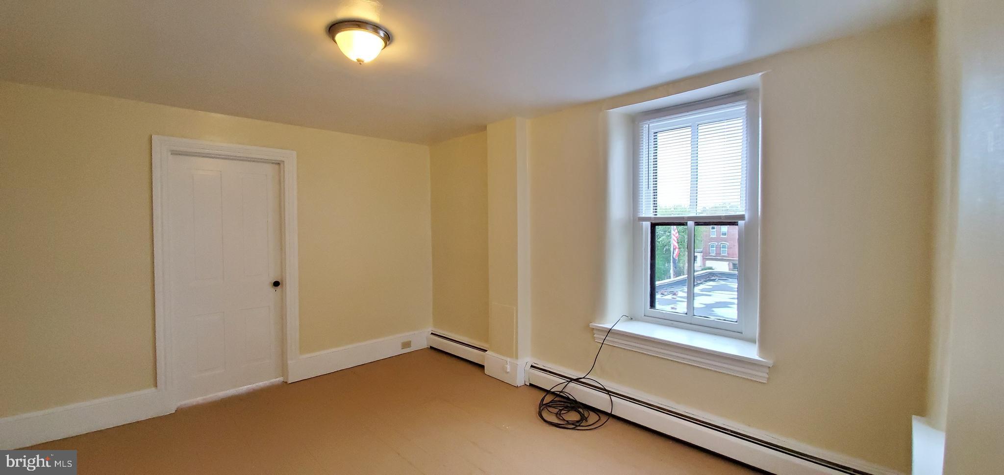 128 New Street Spring City, PA 19475 - Photo 4 of 12 an empty room with windows