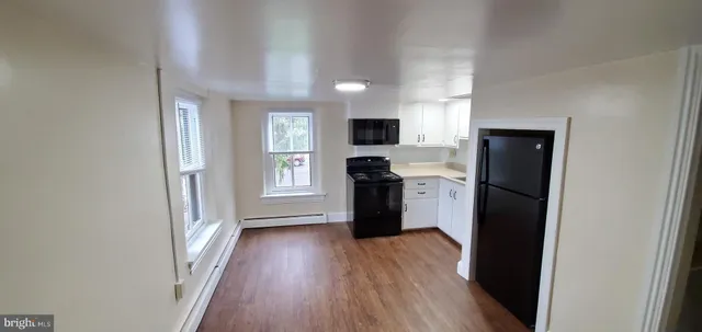 a kitchen with stainless steel appliances a refrigerator sink and cabinets