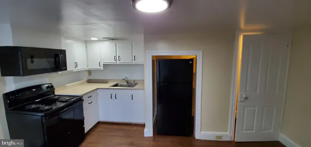 a kitchen with a sink and a stove top oven