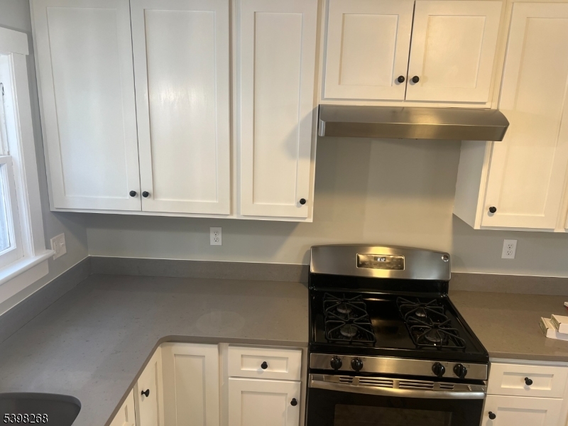 137 Mountain Avenue Gillette, NJ 07933 - Photo 13 of 17 a kitchen with white cabinets and appliances