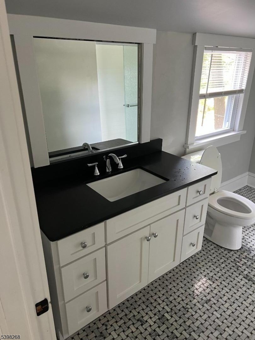 137 Mountain Avenue Gillette, NJ 07933 - Photo 15 of 17 a bathroom with a sink a toilet a window and vanity