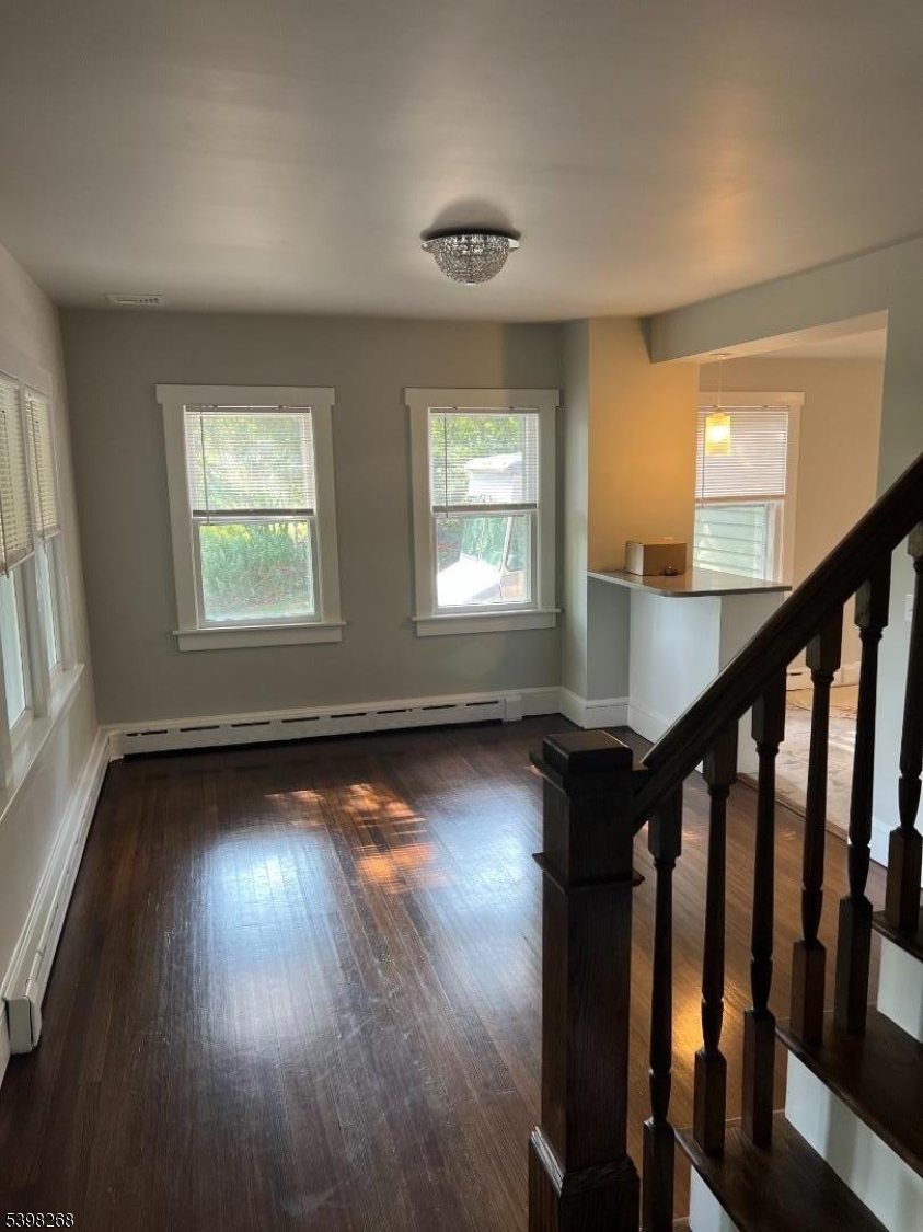 137 Mountain Avenue Gillette, NJ 07933 - Photo 7 of 17 a view of an empty room with wooden floor and a window