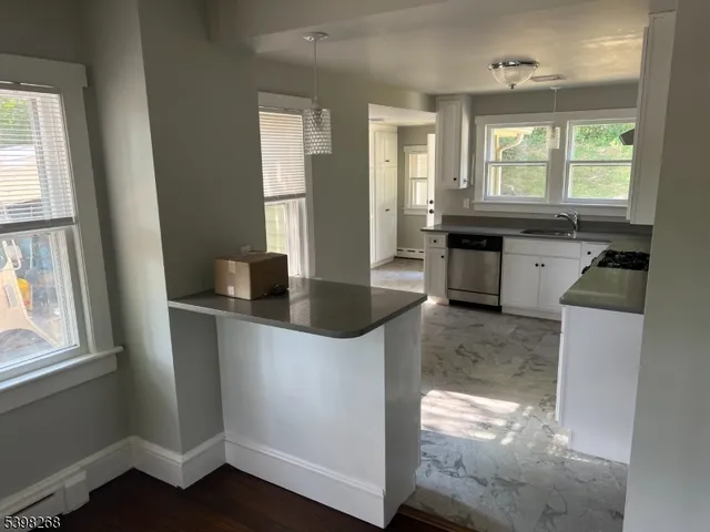 a view of a kitchen cabinets and a wooden floor