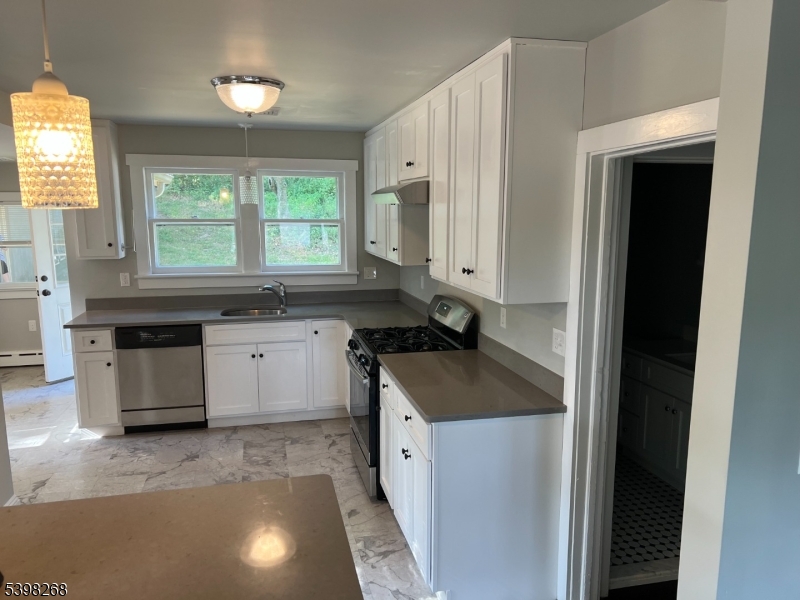 137 Mountain Avenue Gillette, NJ 07933 - Photo 10 of 17 a kitchen with stainless steel appliances granite countertop a sink and a stove