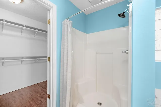 a bathroom with a glass shower door