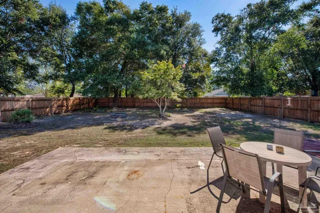 a backyard of a house with table and chairs