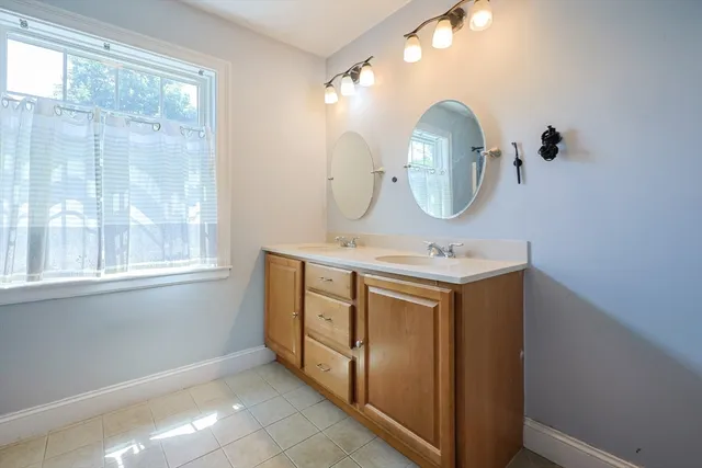 a bathroom with a sink vanity and a mirror