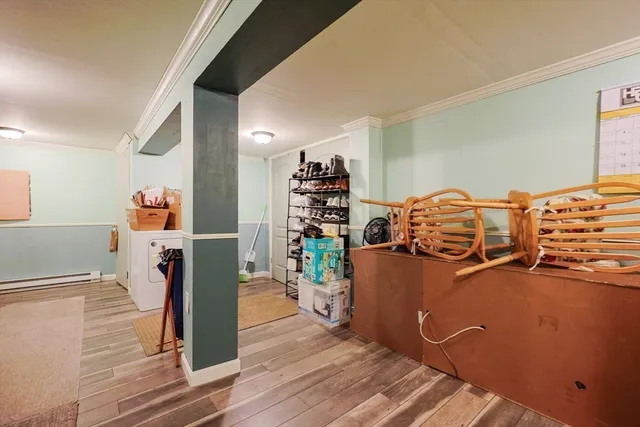 a view of a room with wooden floor and furniture