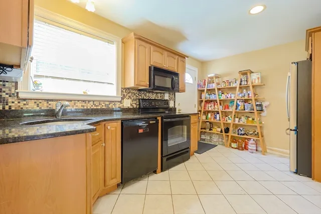 a kitchen with stainless steel appliances a stove sink and microwave