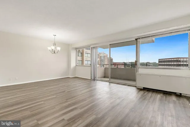 a view of a kitchen with a sink and wooden floor