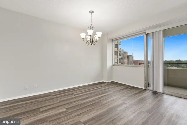 a view of a kitchen with wooden floor and a window