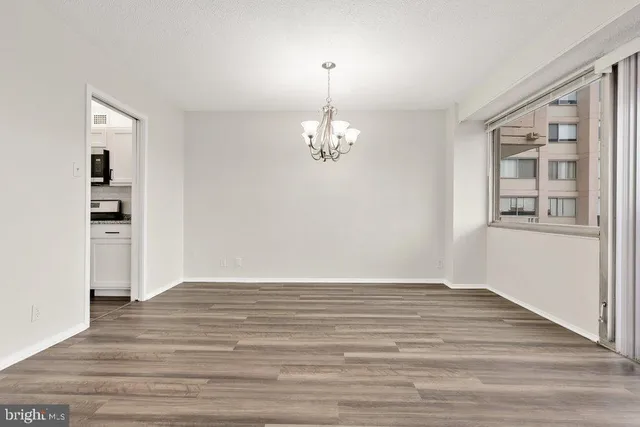 a view of wooden floor and windows in a room