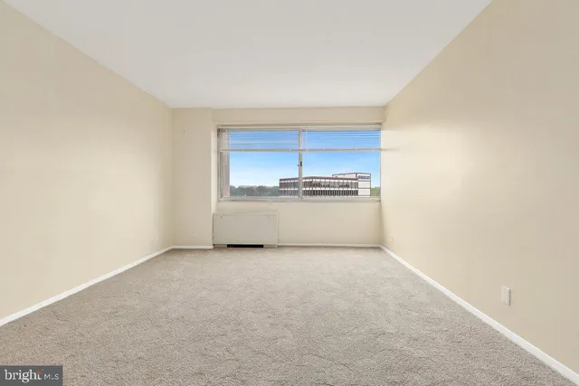 a view of a kitchen with a sink and a refrigerator