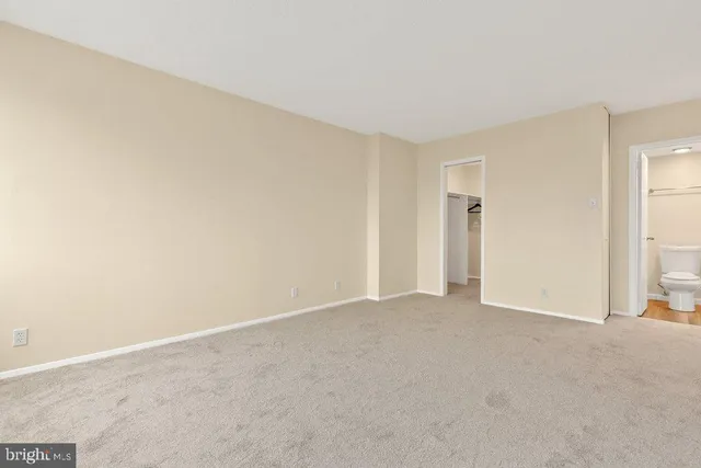 a view of an empty room and closet area