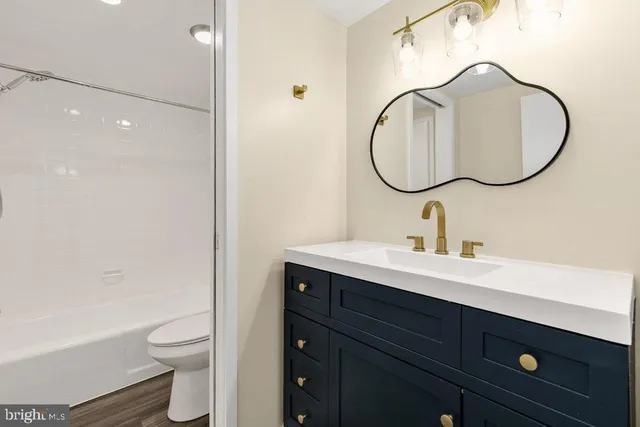 a bathroom with a toilet a sink and a mirror