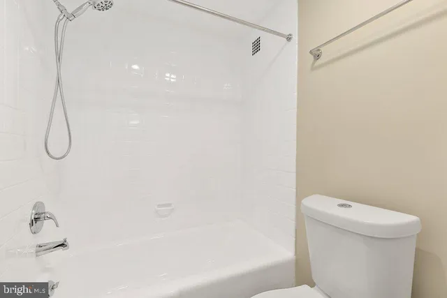 a bathroom with a shower and a toilet