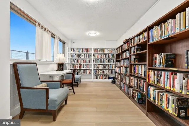 a living room with a book shelf and a book shelf