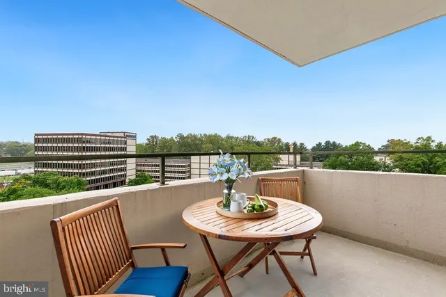 a view of a balcony with a table and chairs