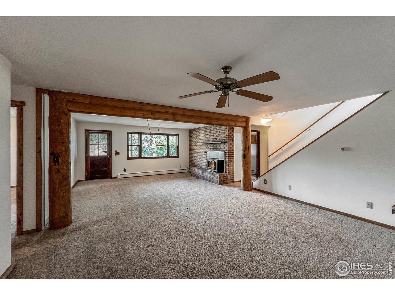 135 Lake Drive Lyons, CO 80540 - Photo 15 of 39 a view of livingroom with a ceiling fan and window