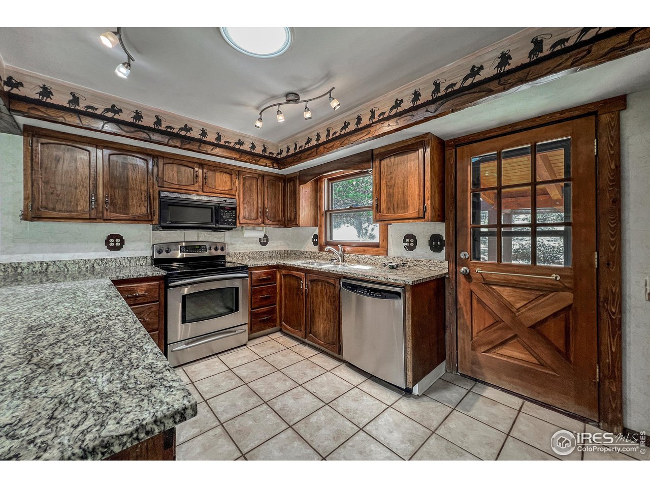135 Lake Drive Lyons, CO 80540 - Photo 3 of 39 a kitchen with a stove a sink and a microwave