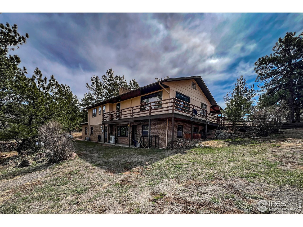 135 Lake Drive Lyons, CO 80540 - Photo 32 of 39 a view of a big house with a big yard and large trees