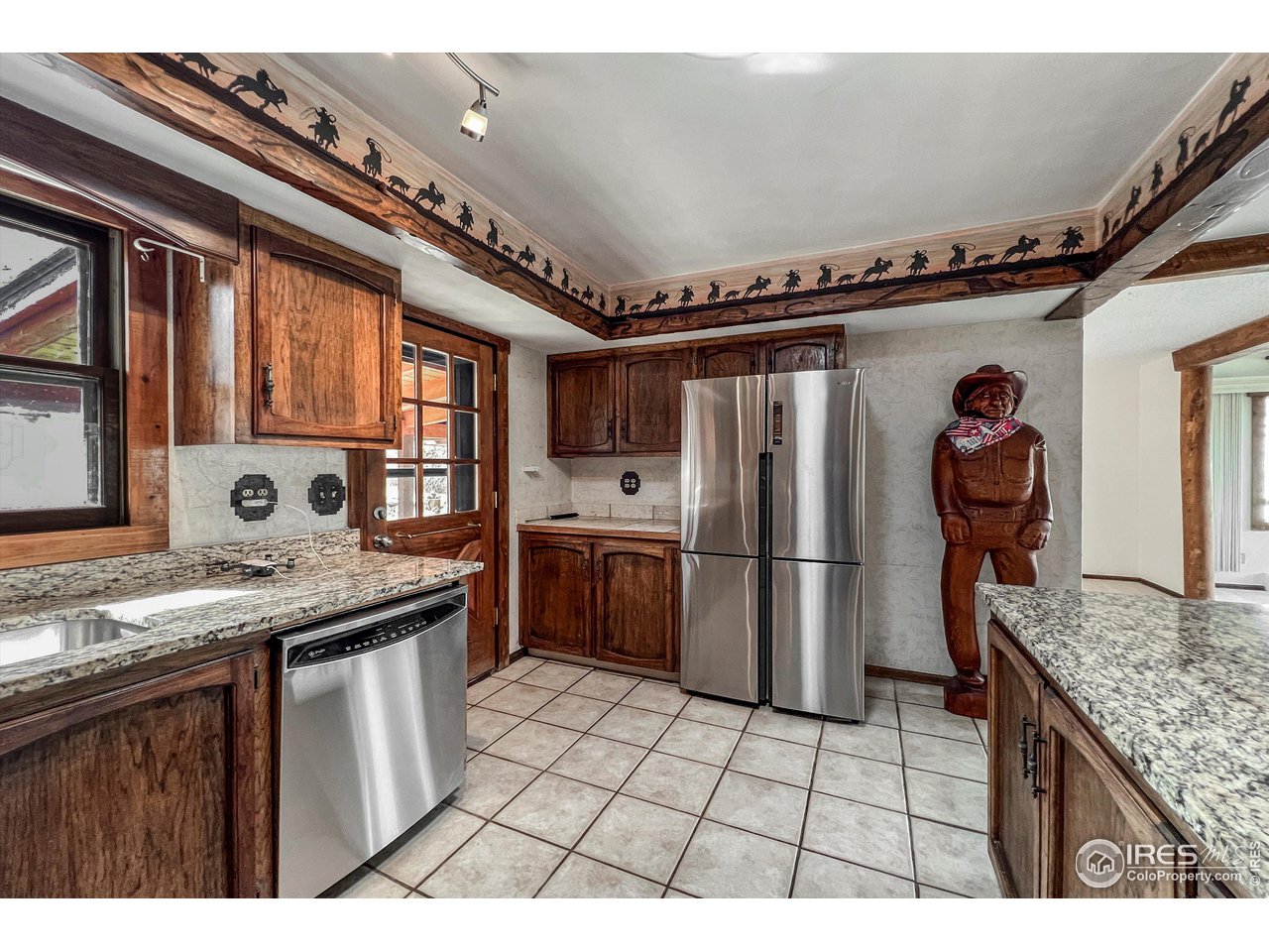 135 Lake Drive Lyons, CO 80540 - Photo 4 of 39 a kitchen with stainless steel appliances granite countertop a sink a stove and a refrigerator