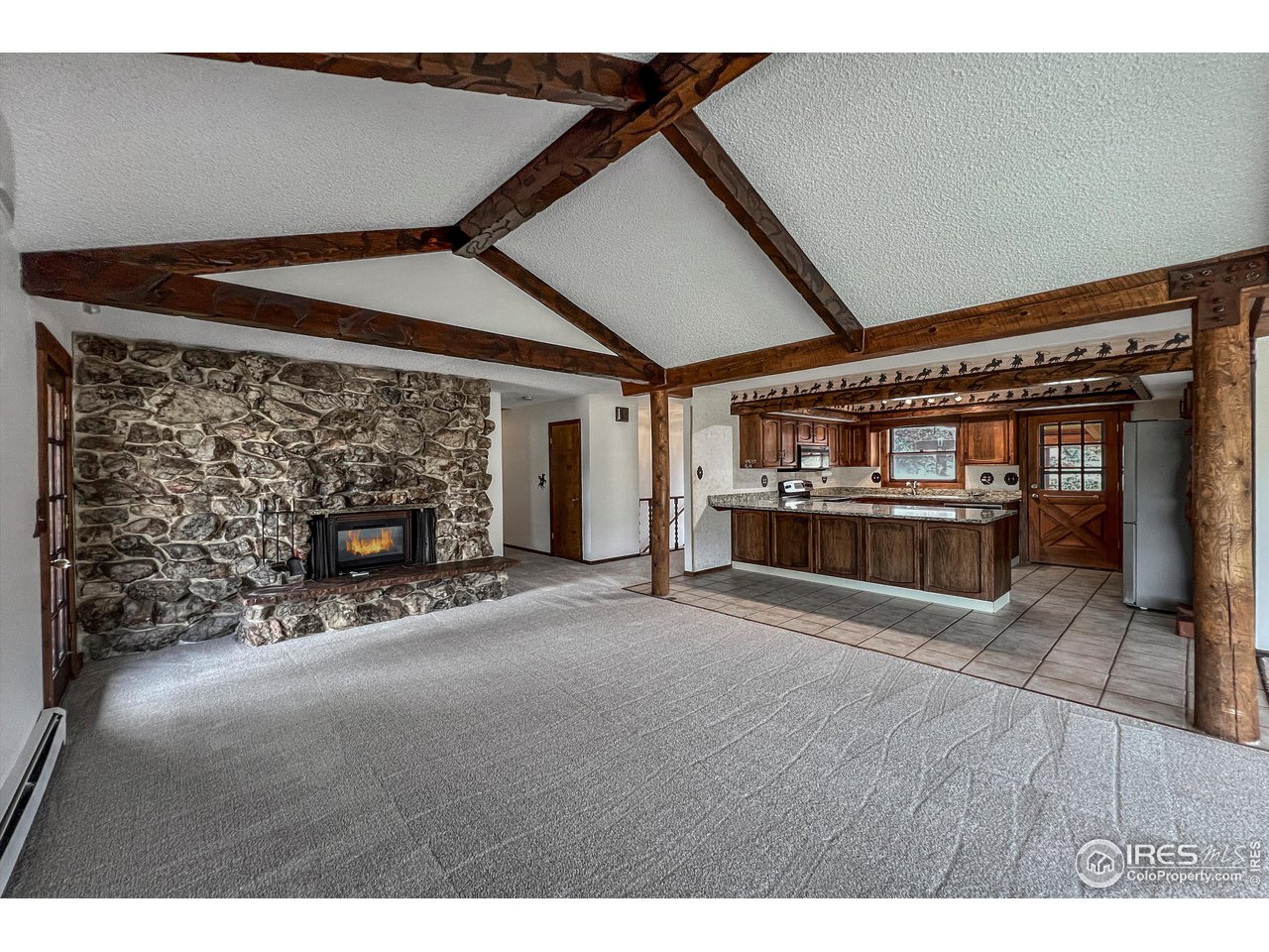 135 Lake Drive Lyons, CO 80540 - Photo 39 of 39 a view of an empty room with fireplace and wooden floor
