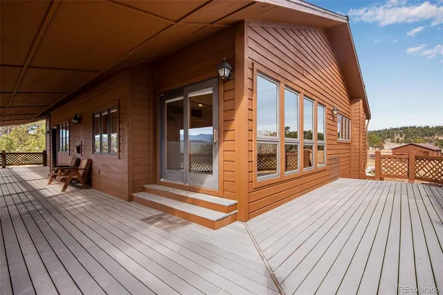 a view of a house with a barbeque and wooden floor