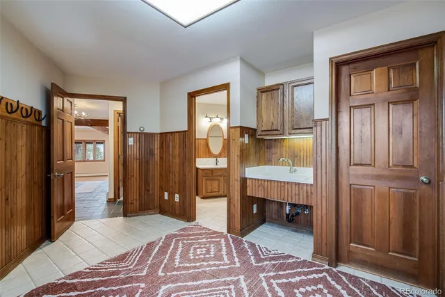 a bedroom with a bed and a refrigerator