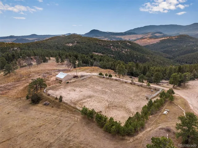 an aerial view of mountain with yard