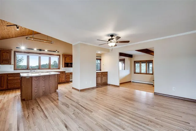 a view of a kitchen with wooden floor and a kitchen
